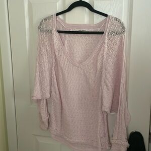 A pink sweater that is lightweight